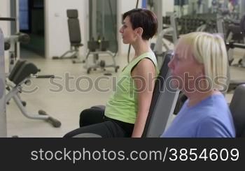 People training in fitness club, gym and sport activity. Two women working out with wellness equipment. 27of27