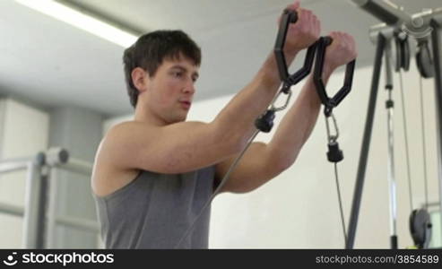People training in fitness club, gym and sports activity. Young man exercising with weights, strong male athlete with wellness equipment. 12of27