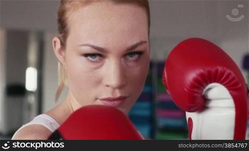 People training, working out, exercise in gym and fitness club, sports and martial arts. Girl, young woman doing boxing, kickboxing for self-defense, portrait looking at camera. 23of29