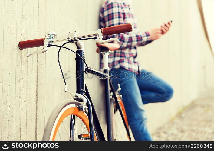 people, transport, leisure and lifestyle - close up of hipster fixed gear bike and man on city street