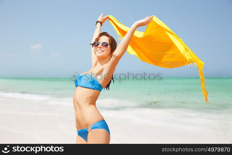 people, travel, summer holidays and vacation concept - beautiful woman in bikini and sunglasses with pareo over exotic tropical beach background. woman in bikini and sunglasses with pareo on beach