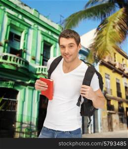 people, travel, tourism and education concept - happy young man with backpack and book travelling over latin american city street background