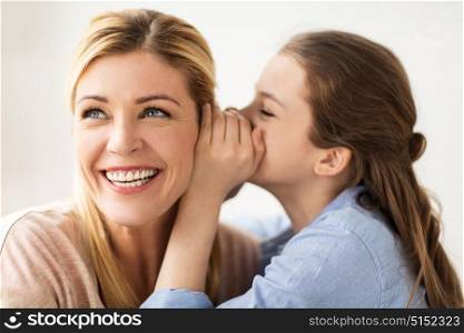 people, trust and family concept - happy daughter whispering secret to her mother. happy girl whispering secret to her mother
