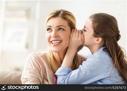 people, trust and family concept - happy daughter whispering secret to her mother at home. happy girl whispering secret to her mother at home