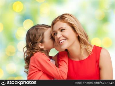 people, trust, love, family and motherhood concept - happy daughter whispering gossip to her mother over green lights background