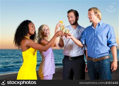 People (two couples) on the beach having a party, drinking and having a lot of fun in the sunset, they are wearing smart casual clothes and drink champagne