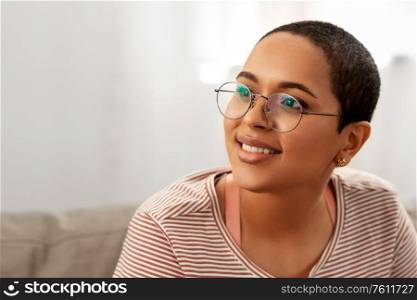 people, vision and leisure concept - portrait of happy smiling african american woman in glasses at home. portrait of african american woman in glasses