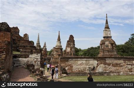 People visiting the Wat Mhathat temple complex in Ayutthaya, central Thailand