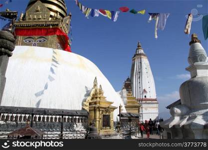 People walk around stupa Swayambhunath in Kathmandu, Nepal