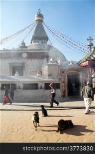 People walk near stupa Bodnth in Kathmandu, Nepal