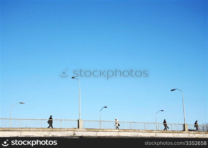 People walking across the bridge