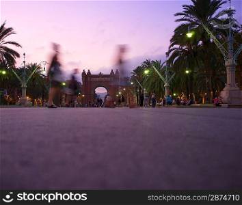 People walking against Triumph Arc in Barcelona