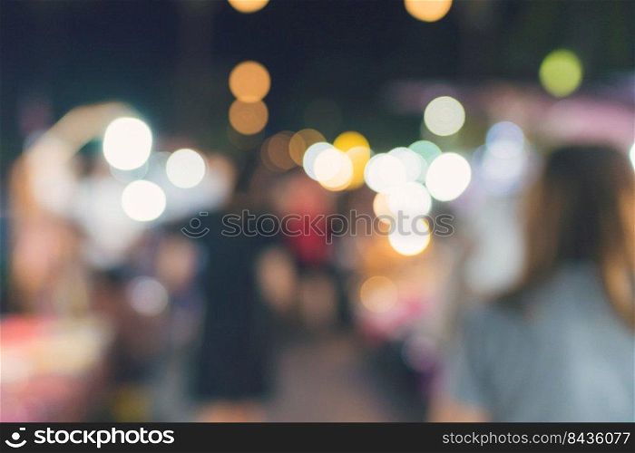 People walking at Festival Event Party night and bokeh Blurred Background.