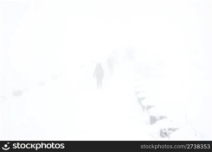 People walking by the road in heavy snowfall