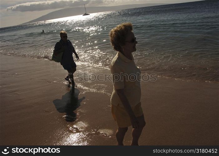 People walking down beach