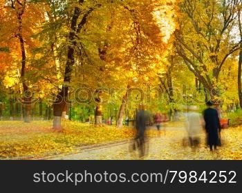 People walking in a autumn park. Long Exposure