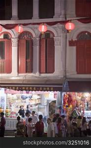 People walking in a market at night, Chinatown, Singapore