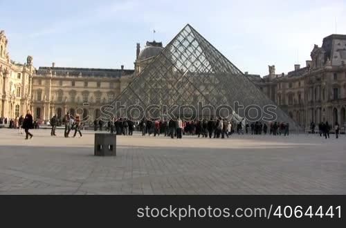 People walking in front of Louvre museum. Please, only editorial use.