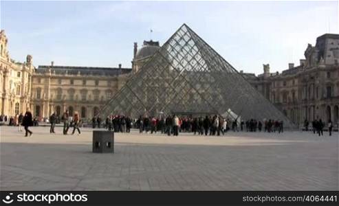 People walking in front of Louvre museum. Please, only editorial use.