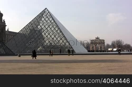 People walking in front of Louvre Museum. Please only editorial use.