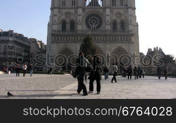 People walking in front of Notre Dame Cathedral, Paris. Recognizable faces, please only editorial use.