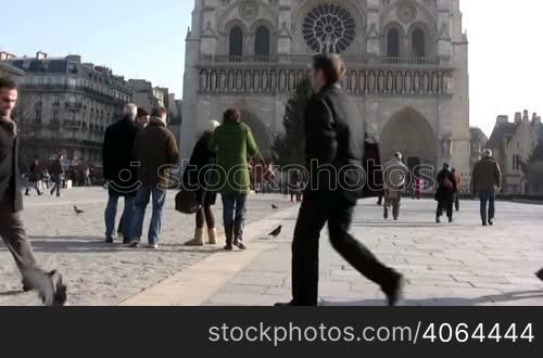 People walking in front of Notre Dame, Paris. Recognizable faces, please only editorial use.