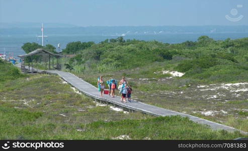 People walking on boardwalk at Ho Hum beach on Fire Island