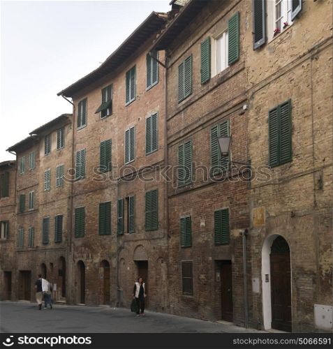 People walking on street amidst buildings, Siena, Tuscany, Italy
