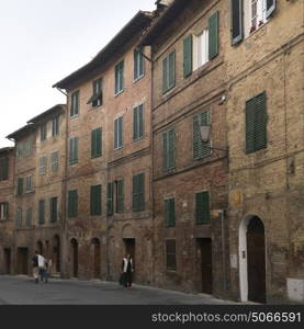 People walking on street amidst buildings, Siena, Tuscany, Italy