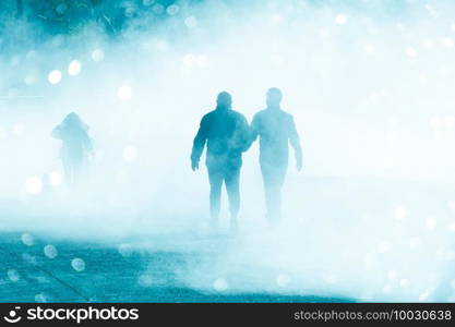  people walking on the street with fog in Bilbao city, spain