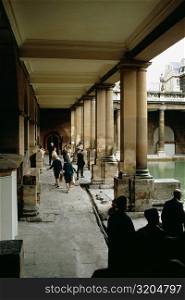 People wandering inside the Roman Baths in England