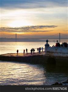 People watching sunset on Lisbon quay. Portugal