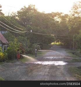 People watering the road in Costa Rica