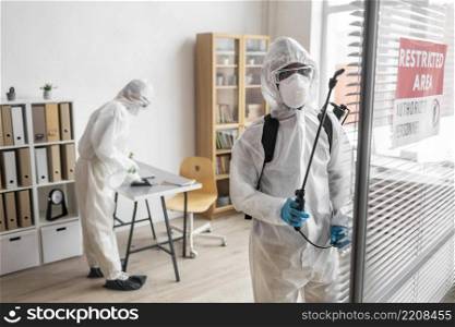 people wearing protective equipment disinfecting dangerous area_2