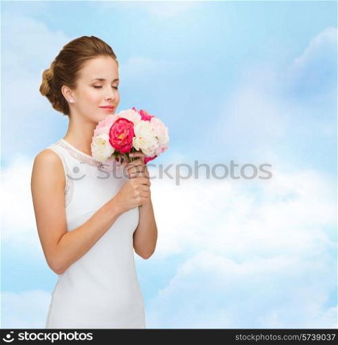 people, wedding, holidays and celebration concept - smiling bride or bridesmaid in white dress with bouquet of flowers over blue cloudy sky background
