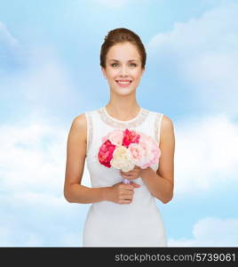 people, wedding, holidays and celebration concept - smiling bride or bridesmaid in white dress with bouquet of flowers over blue cloudy sky background