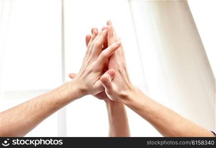 people, win, friendship, teamwork and success concept - close up of hands making high five gesture