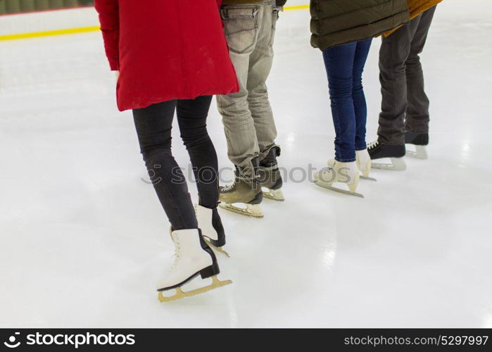 people, winter and leisure concept - close up of friends on skating rink. close up of friends on skating rink