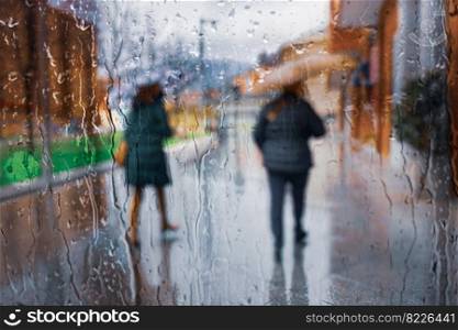 people with an umbrella in rainy days, autumn season, in Bilbao city, Basque country, Spain