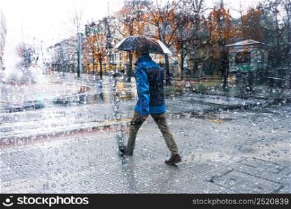 people with an umbrella in rainy days in Bilbao city, Spain