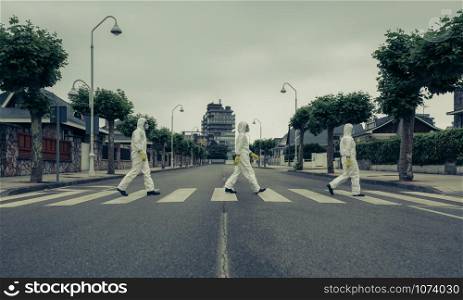 People with bacteriological protection suits crossing a crosswalk in a row. People with bacteriological protection suits in a crosswalk