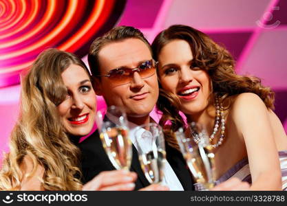 People with champagne in a bar or casino having lots of fun