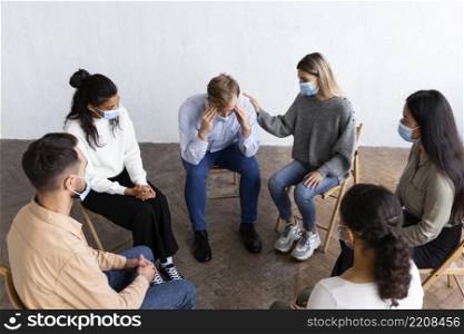 people with medical masks group therapy session