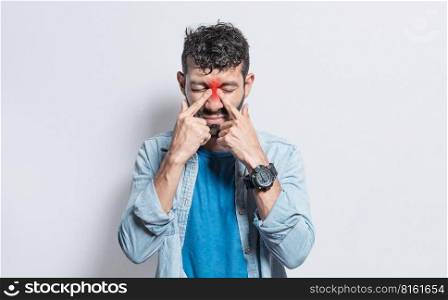 People with pain touching nose. Handsome man with nasal bridge pain, Man with nasal bridge headache. Sinus pain concept