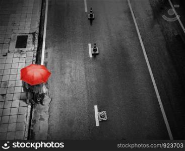People with umbrella on street in rainy day at city