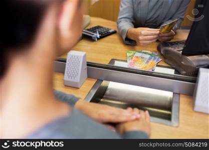 people, withdrawal, money, saving and finance concept - clerk counting swiss francs cash at bank office or currency exchanger. clerk counting cash money at bank office. clerk counting cash money at bank office