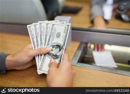 people, withdrawal, saving and finance concept - customer hands with cash money at bank office or currency exchanger. hands with money at bank office or exchanger