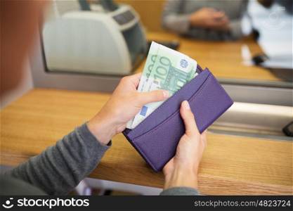people, withdrawal, saving and finance concept - hands with cash money and wallet at bank office or currency exchanger