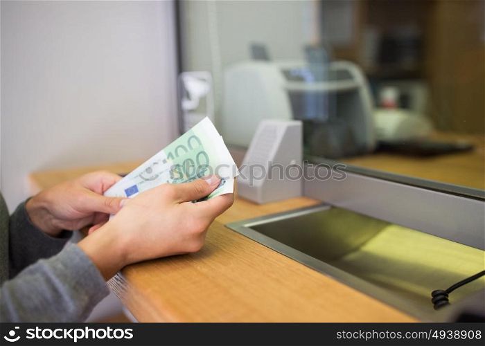 people, withdrawal, saving and finance concept - hands with cash money at bank office or currency exchanger. hands with money at bank or currency exchanger