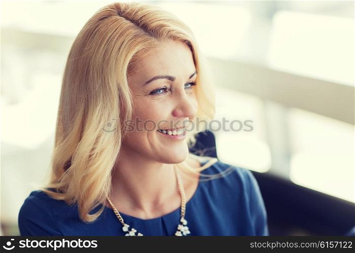 people, women and lifestyle concept - happy smiling blonde woman in blue clothes